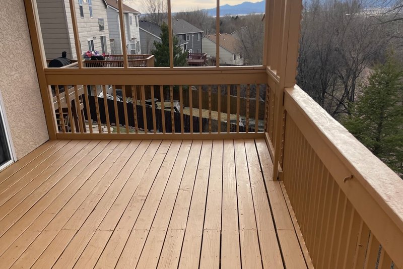 Enclosed porch remodel with a new board floor and a railed window wall