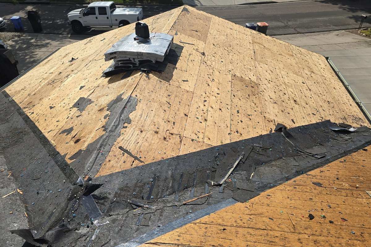 Roof deck stripped to bare sheathing partway through a tear-off