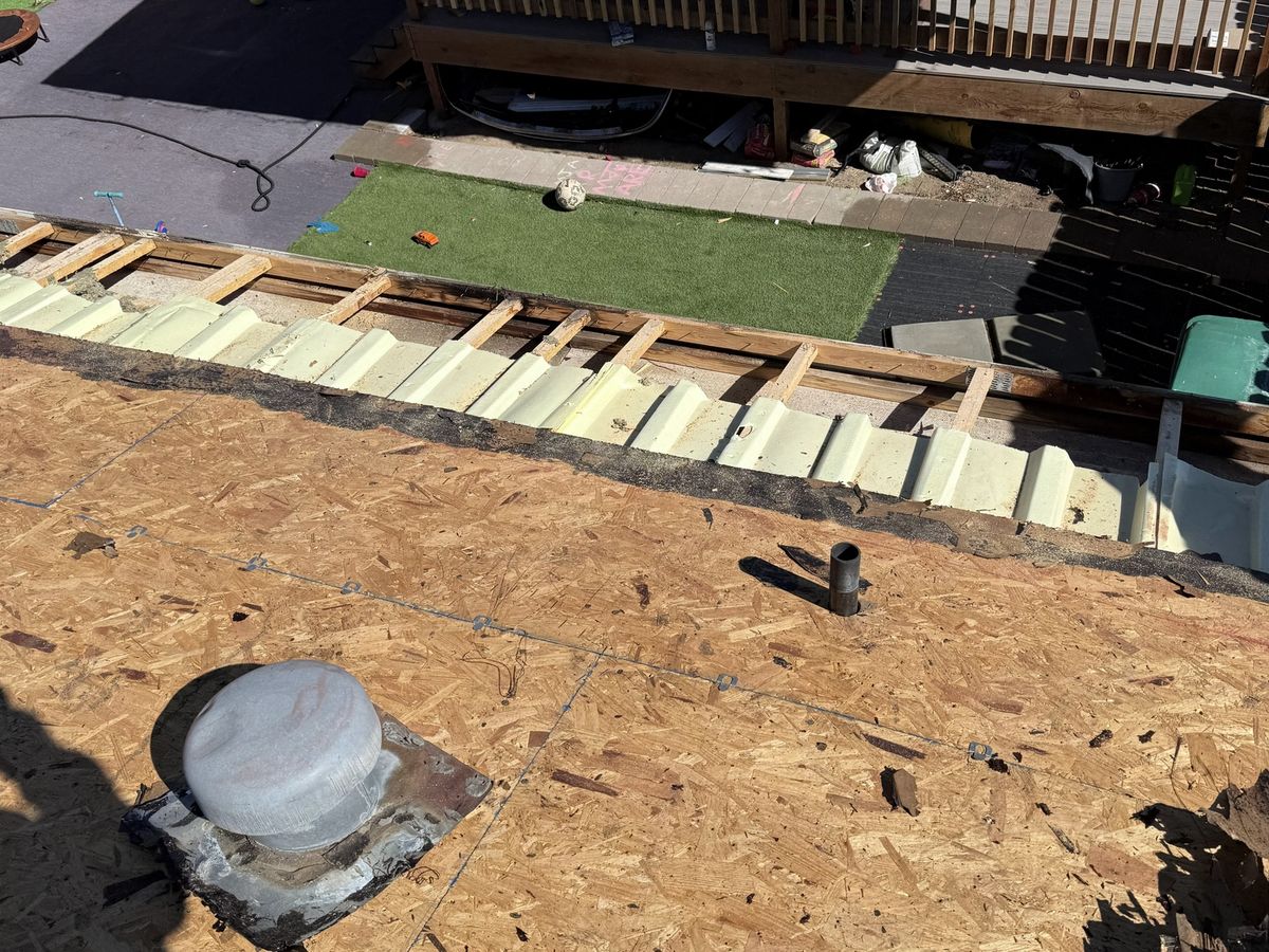 Roof opened to the deck around vents while damaged roofing is removed