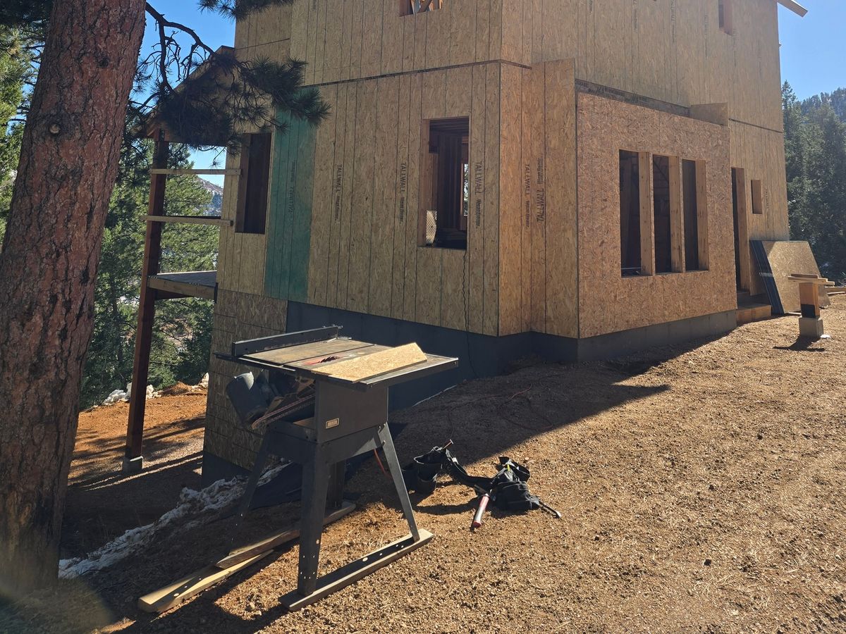 Two-story home addition enclosed in new structural sheathing