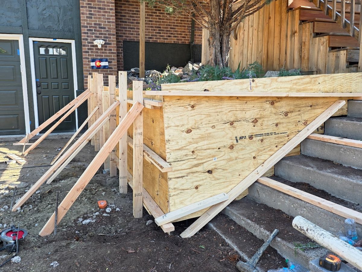 Wood formwork braced in place for a new retaining wall