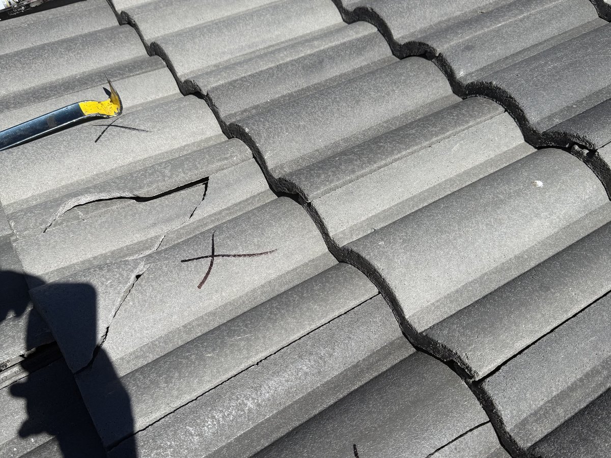 Close view of interlocking roof panels during an inspection