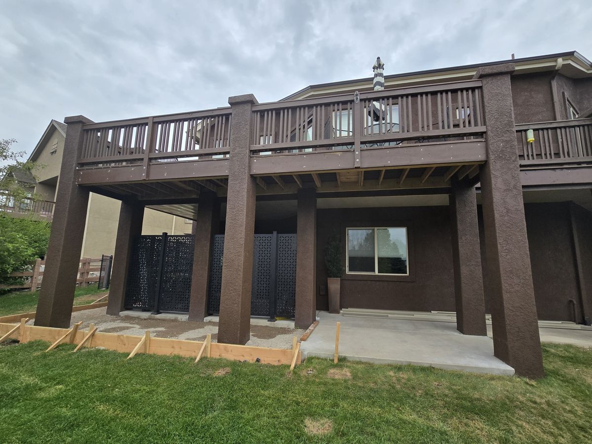 Raised rear deck with a covered patio underneath it