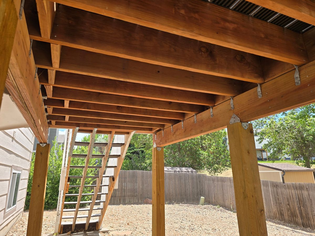 Underside of a deck showing how the beams carry down to the posts