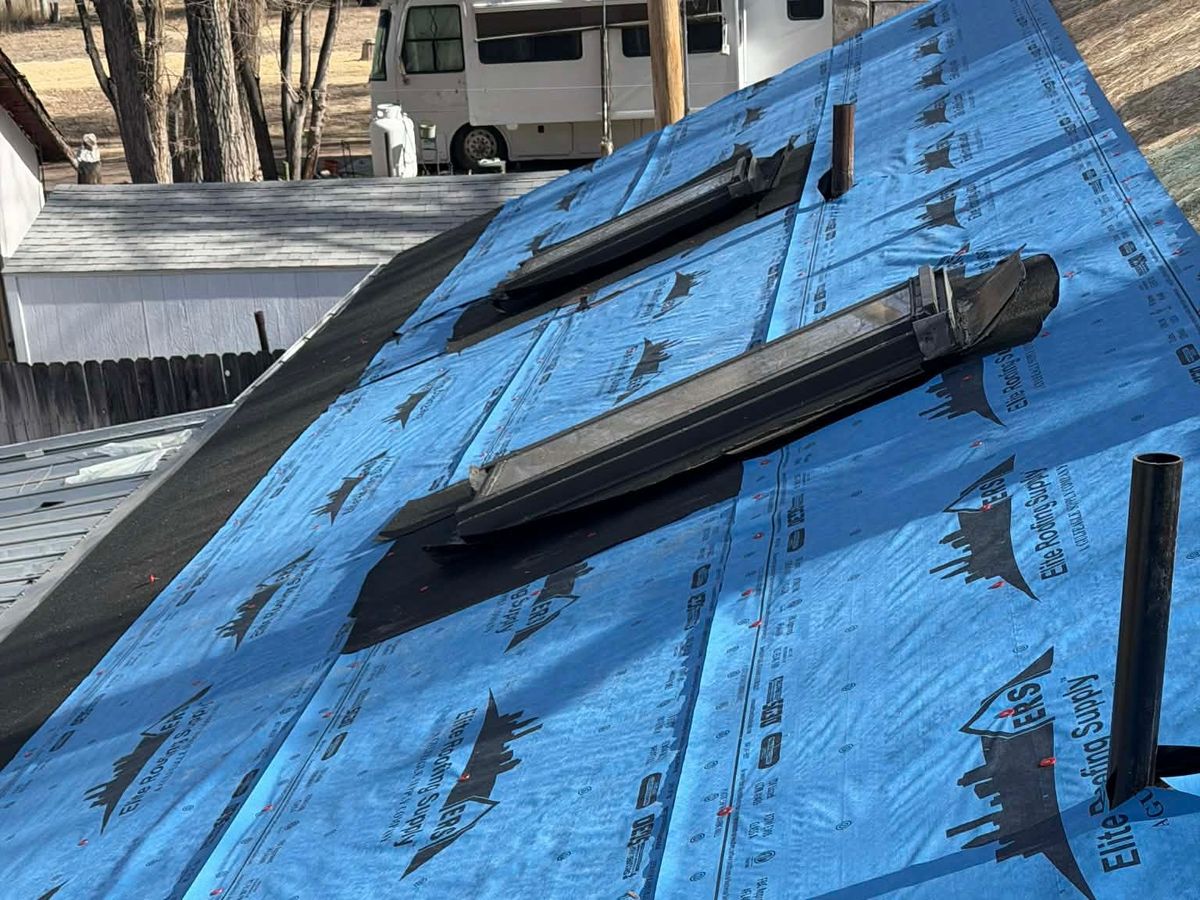Underlayment run around a skylight and a vent pipe before shingles