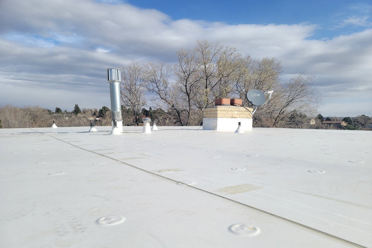 White membrane roof stretching across a commercial building