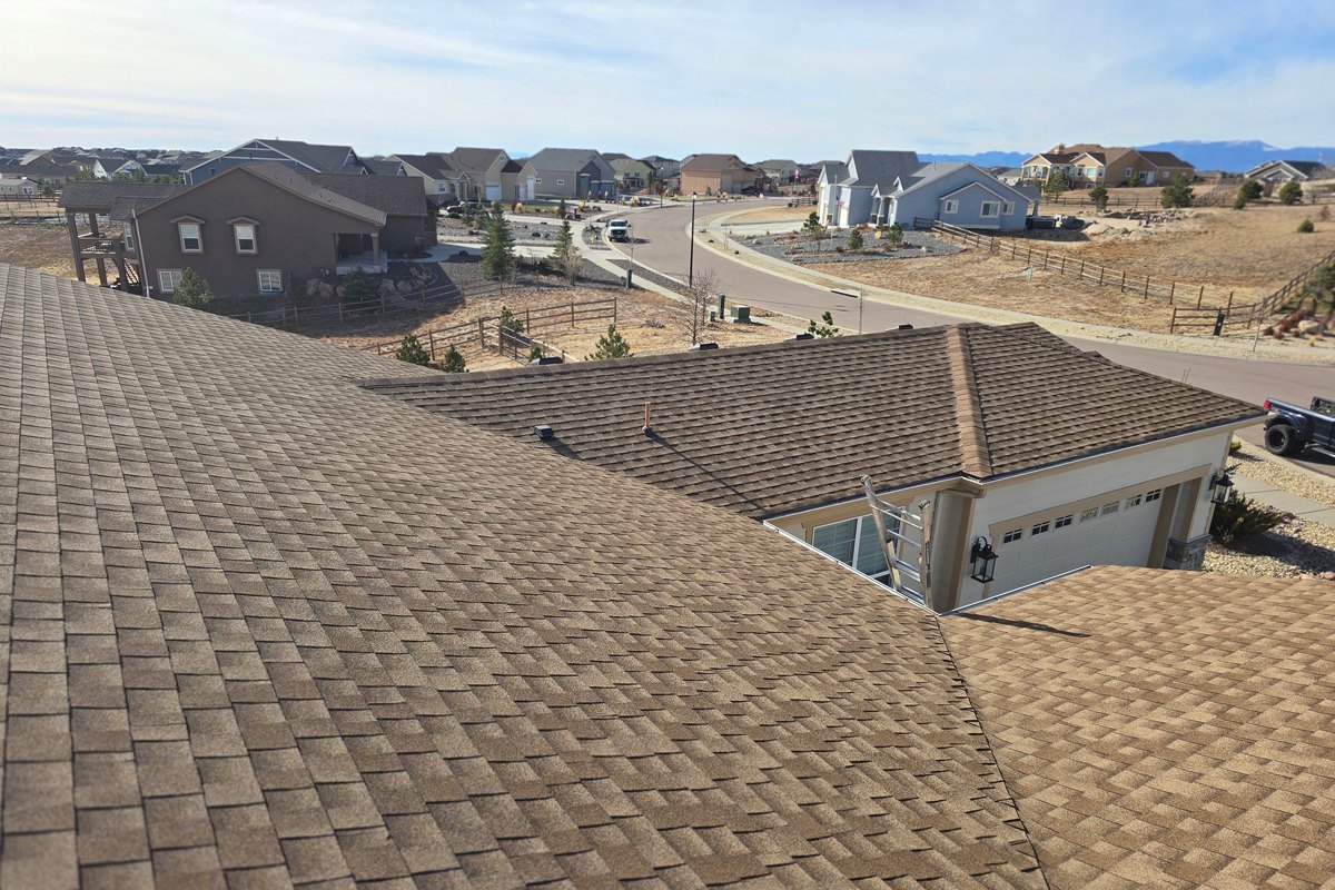 Brown shingle roof looking out over a Colorado Springs neighborhood