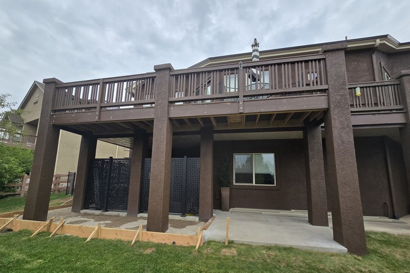 Raised deck and covered patio built onto the back of a family home