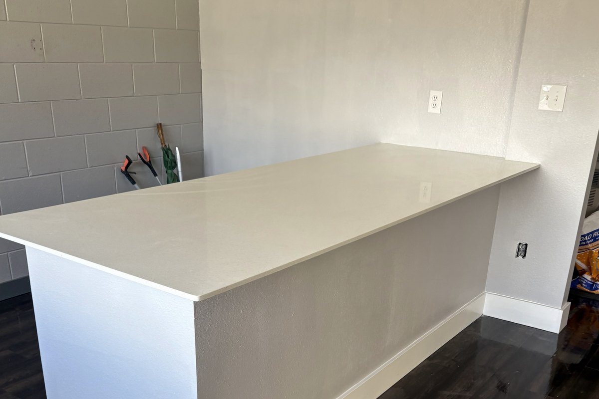 White countertop on a painted base beside an interior wall