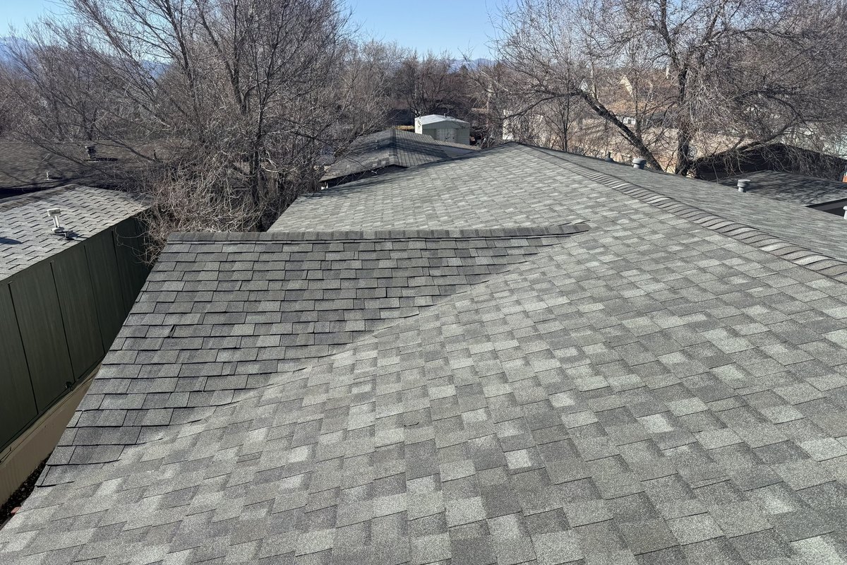 Finished gray architectural shingle roof over a hip and a valley
