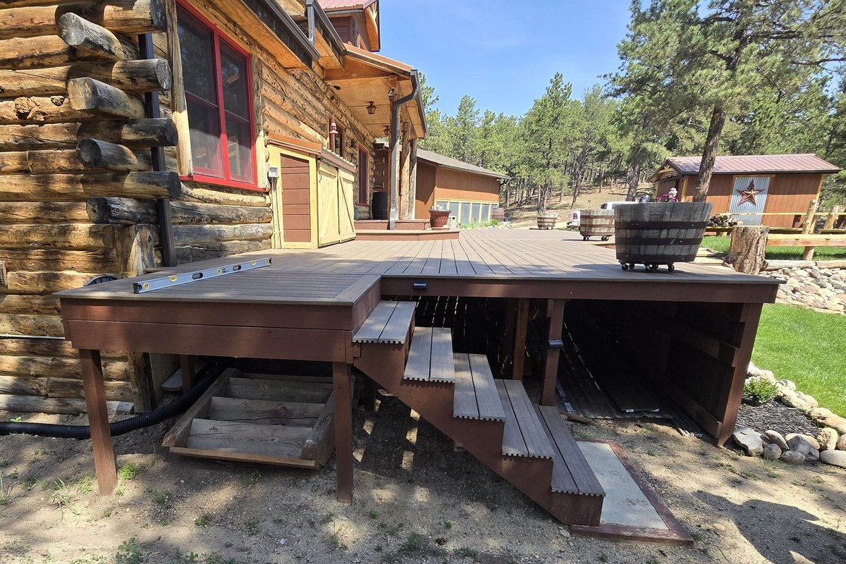 Log home with a newly rebuilt deck and stained timber stairs