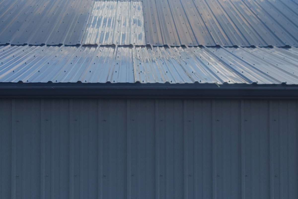 Close view of light-colored ribbed metal roof panels